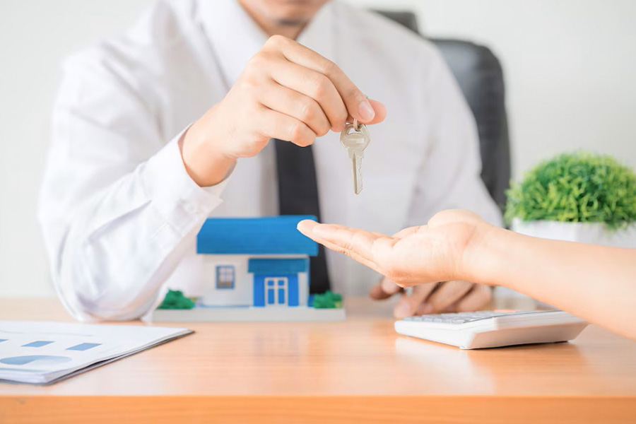 Real estate agent giving clients the house keys